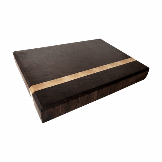 A cutting board product with dark, groovy grains and a stripe of maple running down the left side of it.